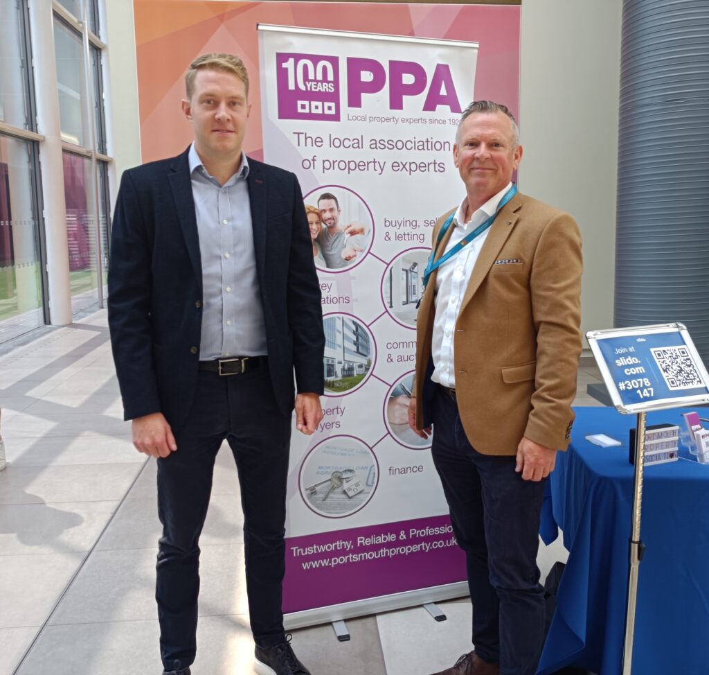 Alex Gauntlett on the left and Nick Cox on the right, in front -either side of the PPA ROller banner at the Lakeside auditorium reception area