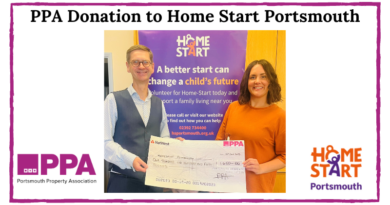 Iain Morrison in smart waistcoat presenting an oversize cheque to Tasha in a lovely orange dress (on brand) in front of a roller banner about the charity Home Start Portsmouth. Happy smiling faces.